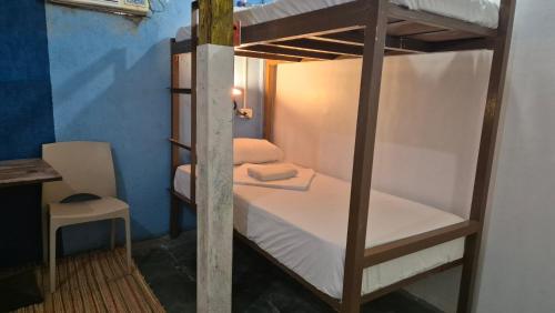 a bunk bed in a room with a table and a chair at Lucy's Diner Hostel Cafe in San Francisco