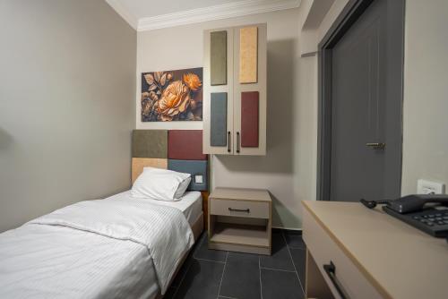 a small room with two beds and a desk at diamond premium hotel in Istanbul