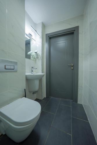 a bathroom with a toilet and a sink and a door at diamond premium hotel in Istanbul