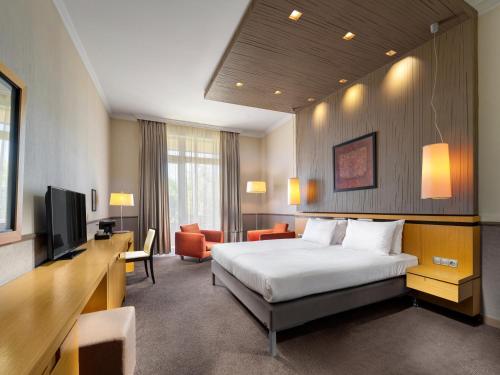 a hotel room with a bed and a television at Mamaison Hotel Andrassy Budapest in Budapest