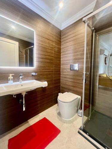 a bathroom with a toilet and a sink and a shower at Rosalina Residences in Birkirkara