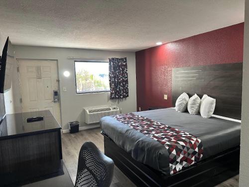 a hotel room with a bed and a window at Rodeway Inn Jonesboro - Atlanta South in Jonesboro