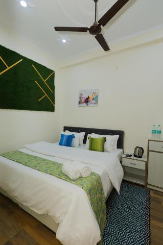 a bedroom with two beds and a ceiling fan at Hotel Pi-Tapovan in Rishīkesh