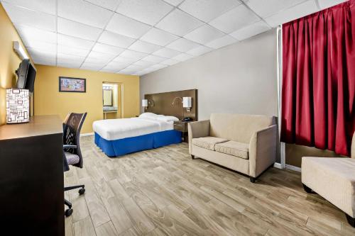 a hotel room with a bed and a desk at Econo Lodge Gretna - New Orleans in Gretna