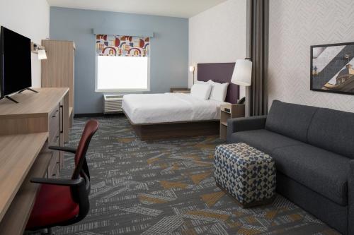 a hotel room with a bed and a couch at Home2 Suites By Hilton Montgomery Downtown in Montgomery