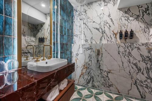 a bathroom with a sink and a shower at George Hotel Launceston, an Ascend Collection Hotel in Launceston