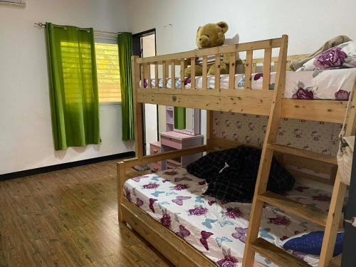 a bedroom with bunk beds with a teddy bear on top at CasaOlivia in Puerto Galera