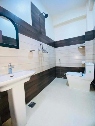 a bathroom with a sink and a toilet at Namaste Guest House in Pokhara