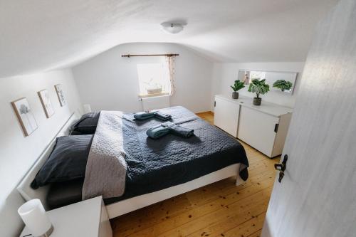 a bedroom with a large bed in a white room at Ferienhaus Waldzeit in Heimbach