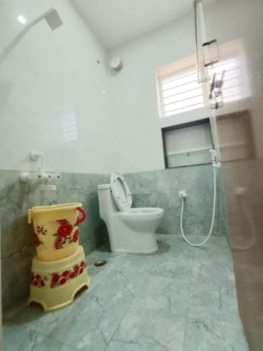 a bathroom with a toilet and a shower in it at RV Comforts in Perambalūr
