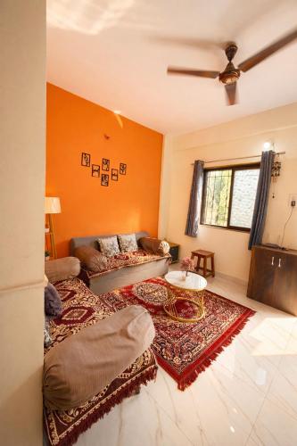 a living room with a couch and a table at The Calm Courtyard- Pune in Pune