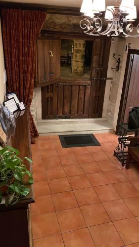 a room with a tile floor and a chandelier at La Posada de Leza in Laguardia