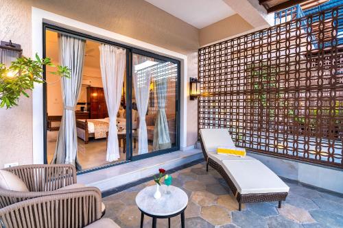 a balcony with a room with a bed and a table at Amrutham Bagh Resort & Spa in Udaipur