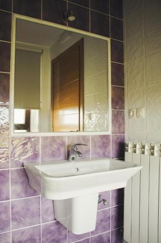 a bathroom with a sink and a mirror at Albergue Camino Norte in Castropol