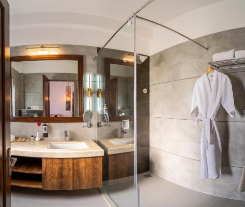 a bathroom with two sinks and a glass shower at Amrutham Bagh Resort & Spa in Udaipur