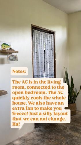 a sign in front of a window in a room at Ayu Homestay - Room 4 in San Isidro