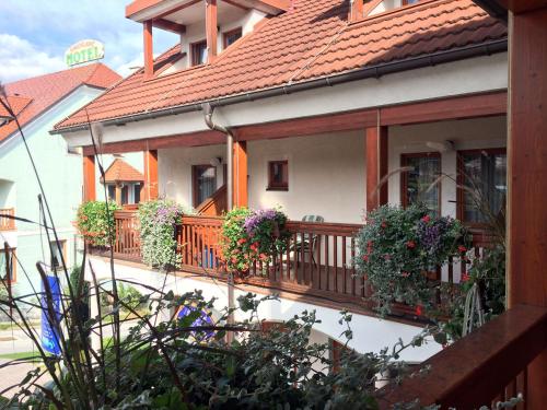 a house with a balcony with flowers on it at Garni Hotel Zvon in Zreče