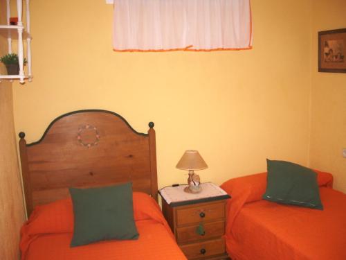 a bedroom with two beds and a table with a lamp at Apartment Martinez Casablanca in Alcossebre