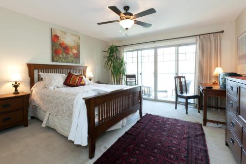 a bedroom with a bed and a ceiling fan at OKeefes Landing Bed & Breakfast in Vernon