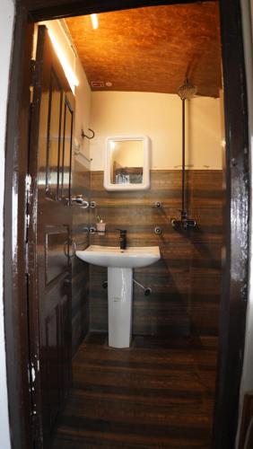a bathroom with a sink and a mirror at Burj Resort in Ban
