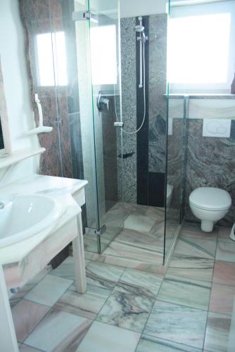 a bathroom with a shower and a sink and a toilet at Appartement Pürstinger in Altenmarkt im Pongau