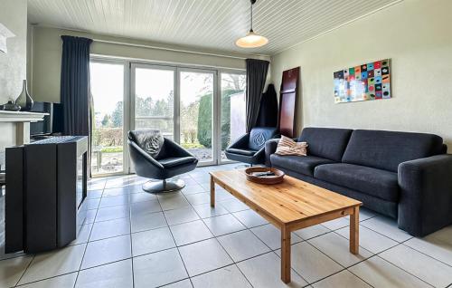 a living room with a couch and a table at 2 Bedroom Nice Home In Rendeux in Rendeux