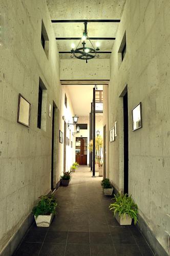 a hallway of a building with potted plants and a ceiling at Hoteles Riviera Mansion in Arequipa