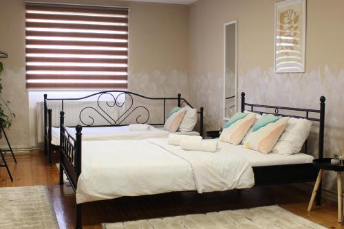 a bedroom with a bed with white sheets and pillows at Picante apartment in Srbobran