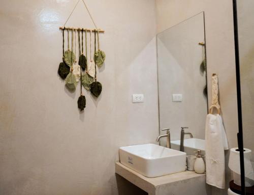 a bathroom with a sink and a mirror at The Hide El Nido Villas in El Nido