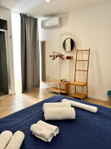 a room with three towels on a blue rug at A Casuzza di Giú Giú - NUOVA GESTIONE in Agrigento