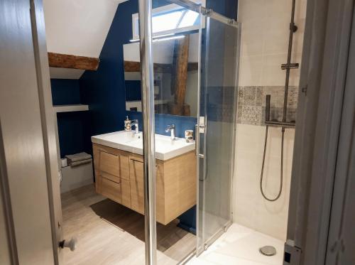 a bathroom with a sink and a shower at Maison Maubert in Thiers