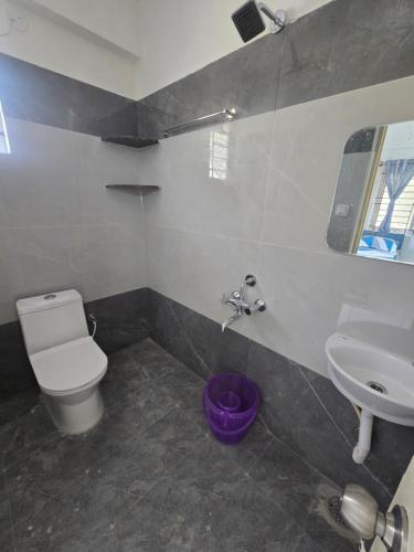 a bathroom with a toilet and a sink at Om Sai Ram Coliving in Bangalore