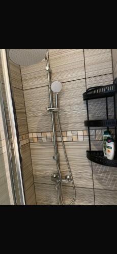 a shower head in a bathroom with a shelf at Seafront Home in Larnaca