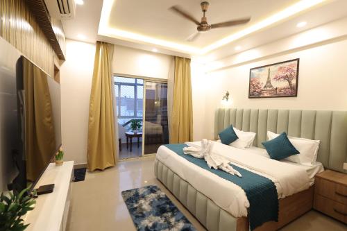 a bedroom with a bed and a television in it at Navrasa By CDF in Vrindāvan