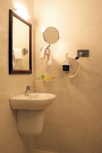 a bathroom with a sink and a mirror at Hotel Searock in Trivandrum