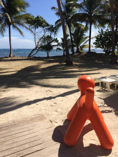 an orange object is sitting on the beach at Be On The Beach in Sainte-Anne