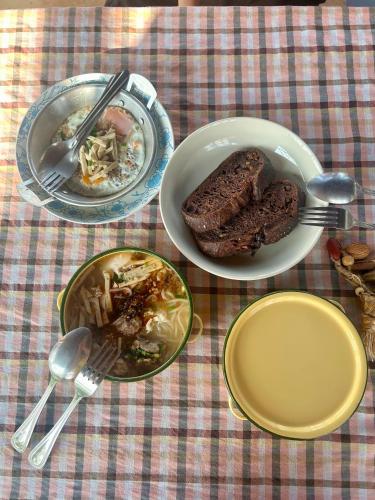 a table with plates of food on a table at Ponko Home in Ban Si Than