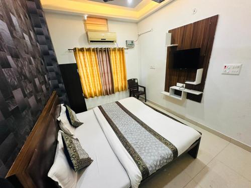a bedroom with a bed and a television in it at Hotel Lake View in Varanasi