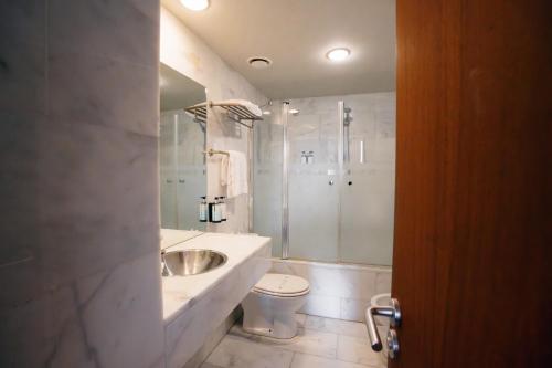 a bathroom with a sink and a toilet and a shower at Hostatgeria de Poblet in Poblet