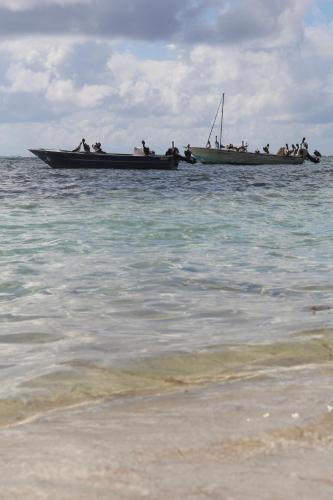 two boats in the water next to a beach at Be On The Beach in Sainte-Anne