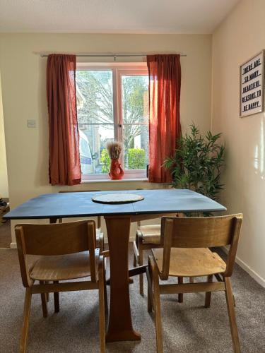 a dining room with a table and two chairs at The Garden Haven in Cheddar