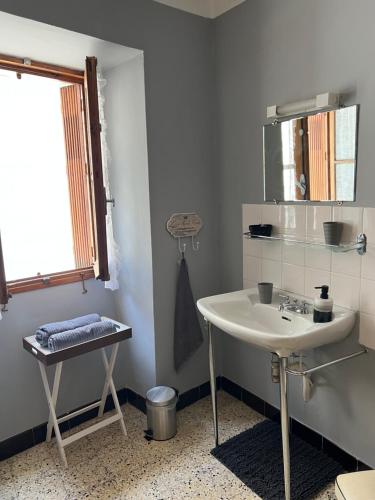 a bathroom with a sink and a mirror at Dumas St-Germain de calberte in Saint-Germain-de-Calberte