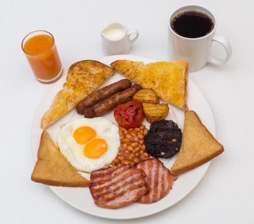 a plate of breakfast food with eggs bacon and toast at I Rovers in Pattaya