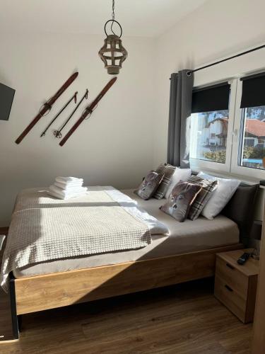 a bedroom with a bed with pillows and a chandelier at Appartements Bergliebe in Bichlbach