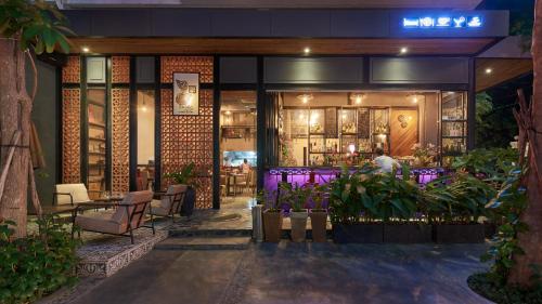 a restaurant with purple lighting and a bar at Monsoon Bassac Hotel in Phnom Penh