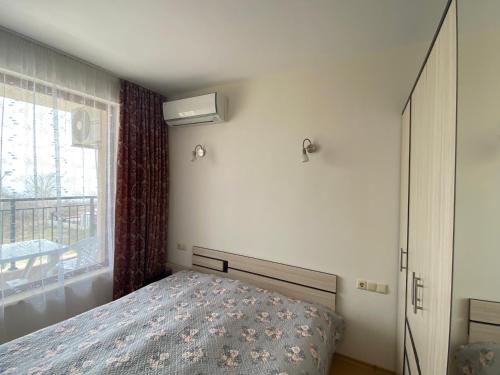 a bedroom with a bed and a window at Изгрев-Бяла in Byala
