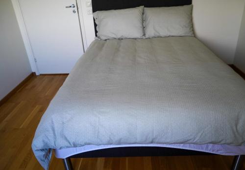 a bed in a small room with a mattress at Solrik leilighet på Byåsen in Trondheim