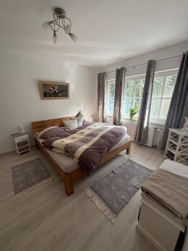 a bedroom with a large bed and a large window at Ferien im Bomlitztal in Bomlitz