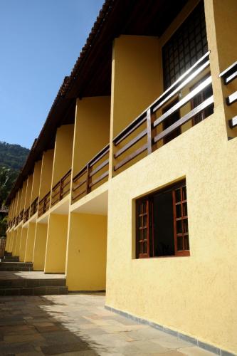 a building with balconies on the side of it at Hotel da Ilha in Ilhabela