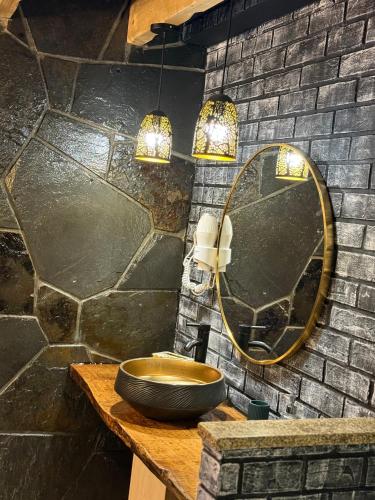 a bathroom with a sink and a mirror on a wall at Refúgio Muas Nature in Vila Real